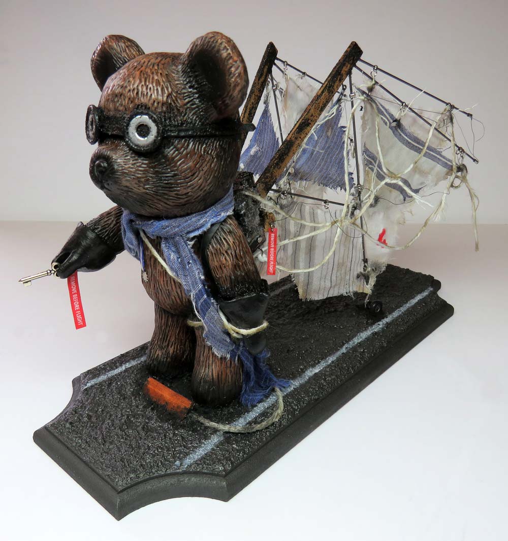 An aviator flying popobe bear with wings on a runway